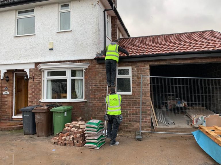 Roofer & Builder team on ladders during a house extension project