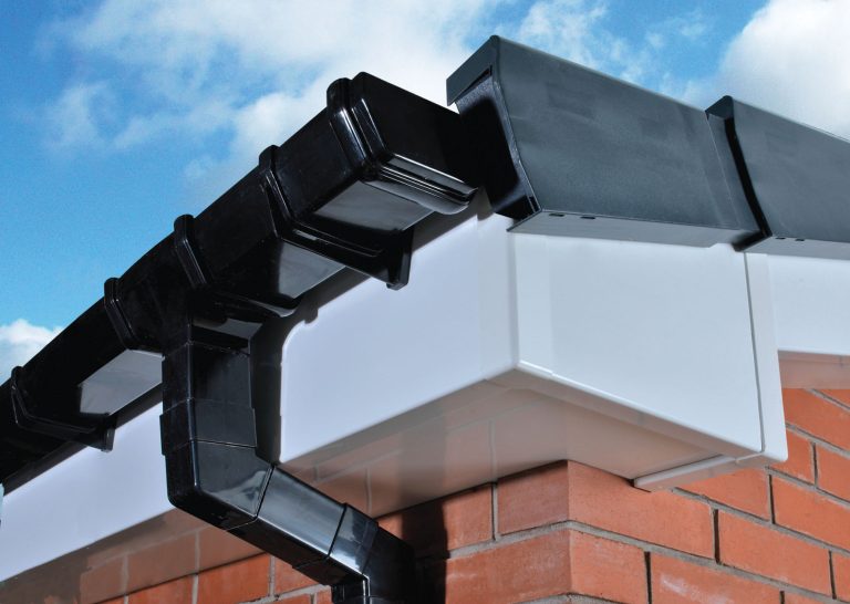 Black uPVC gutters fitted to new white fascia boards