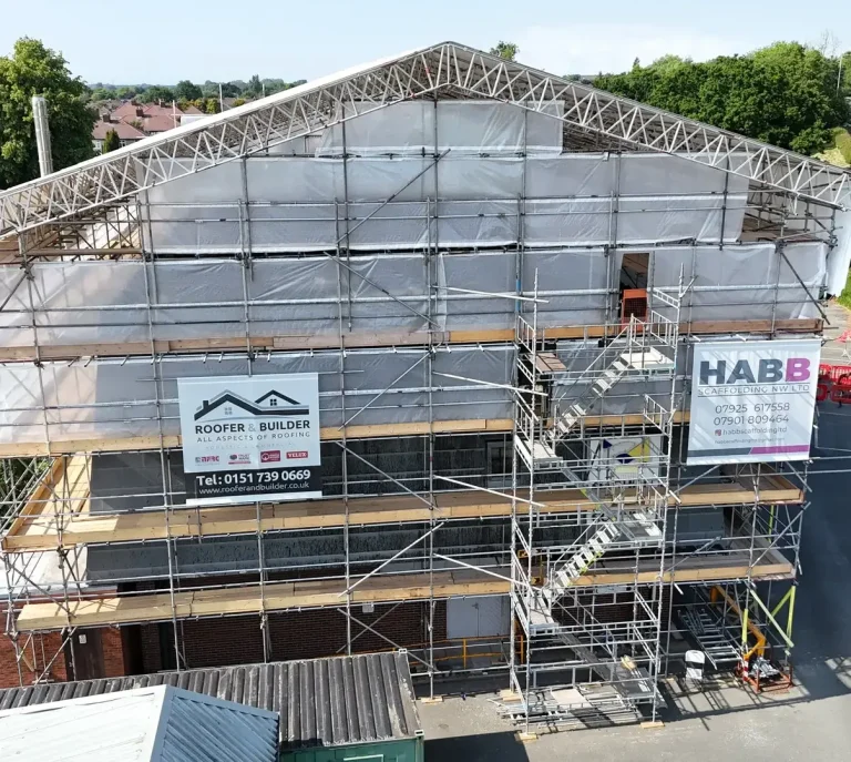 Building under scaffolding with Roofer & Builder site banners