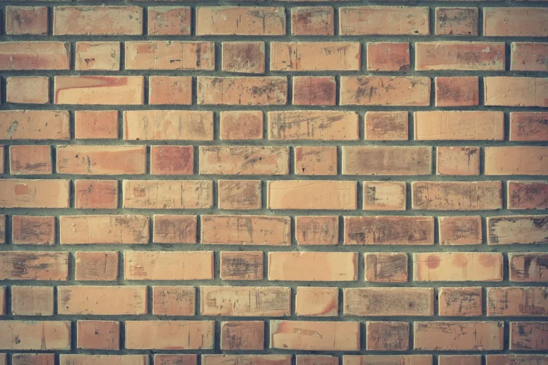 Repointed brick wall with fresh mortar joints