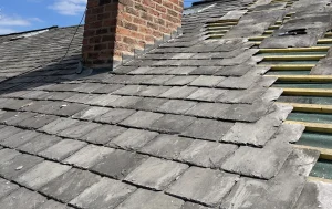 Slate roof with a brick chimney stack